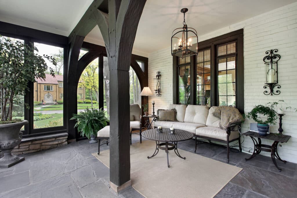 porch with wood beams and stone flooring