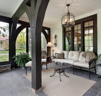 porch with wood beams and stone flooring